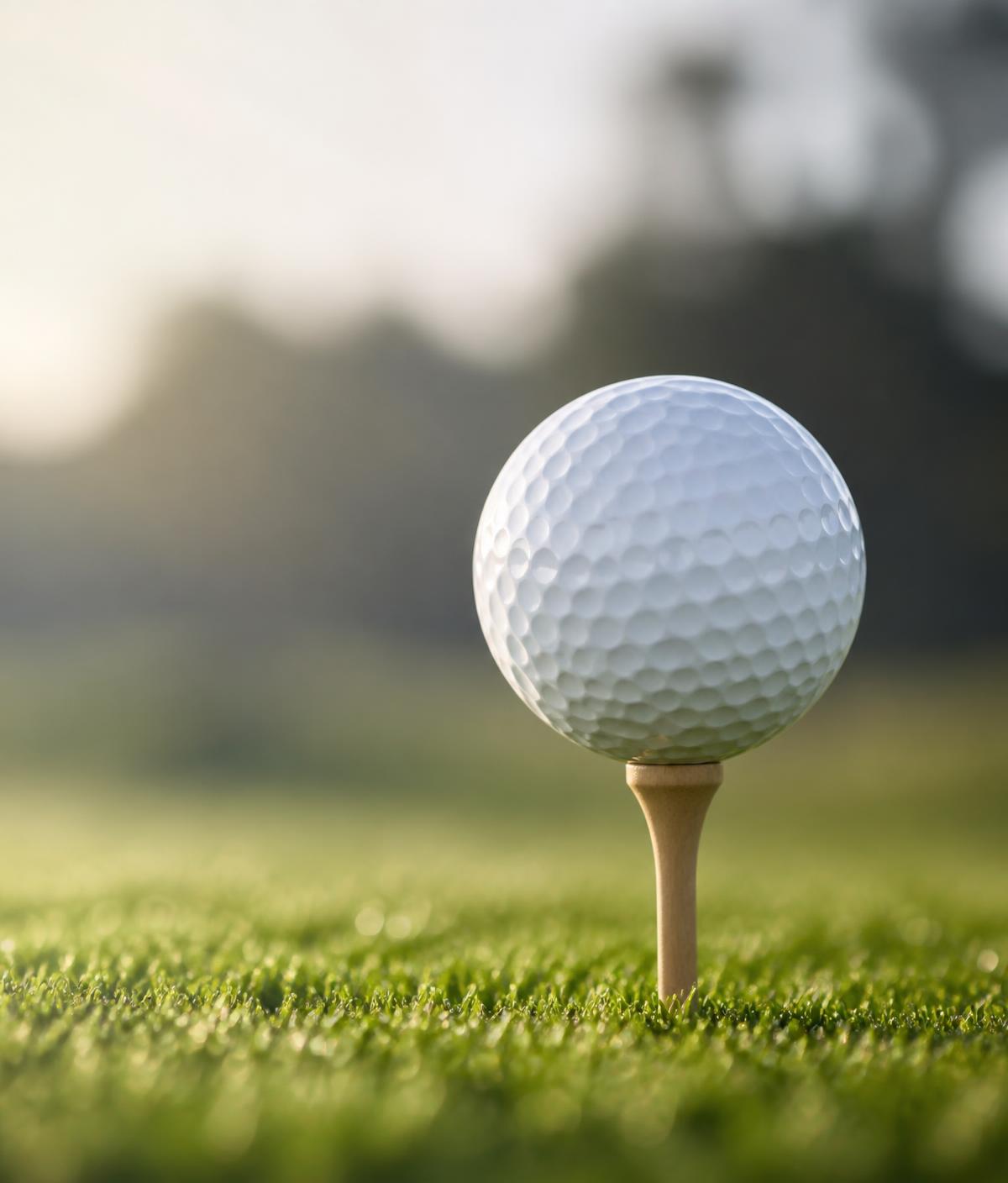 Golf ball on a tee at sunrise